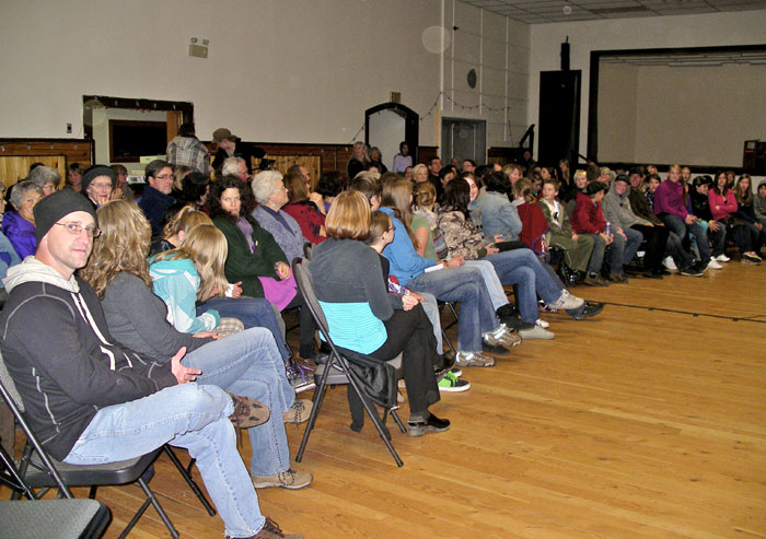 People sitting on chairs in a hall