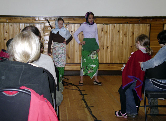 Two girls giving a presentation in the hall